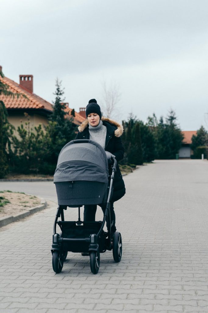 woman and her baby inside a baby pram