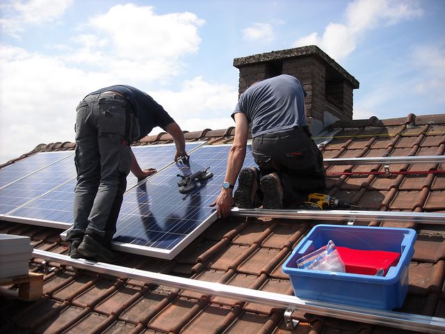 two men installing commercial solar