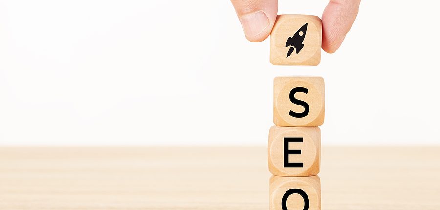 Wooden block with rocket icon and SEO letters